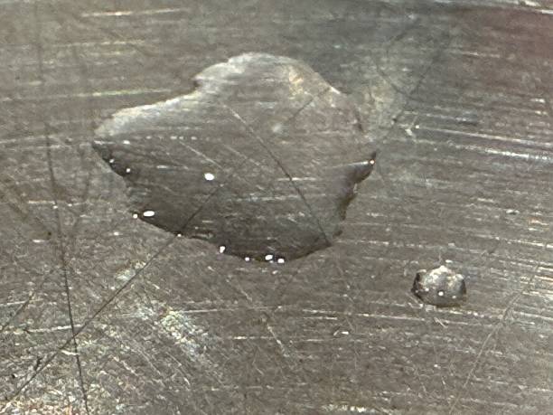 istock Heart shaped droplet on metal 2192189561