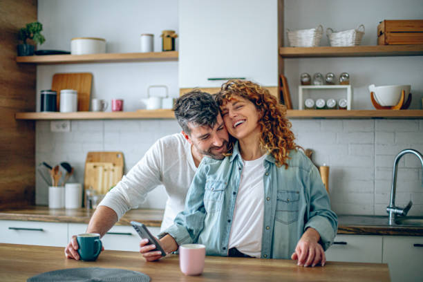 istock Romantic couple sharing a tender moment while having morning coffee in their contemporary kitchen 2192189630