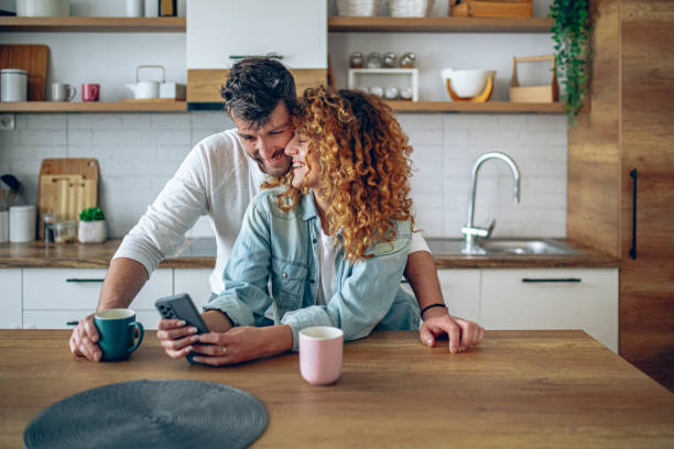 istock Romantic couple sharing a tender moment while having morning coffee in their contemporary kitchen 2192189722