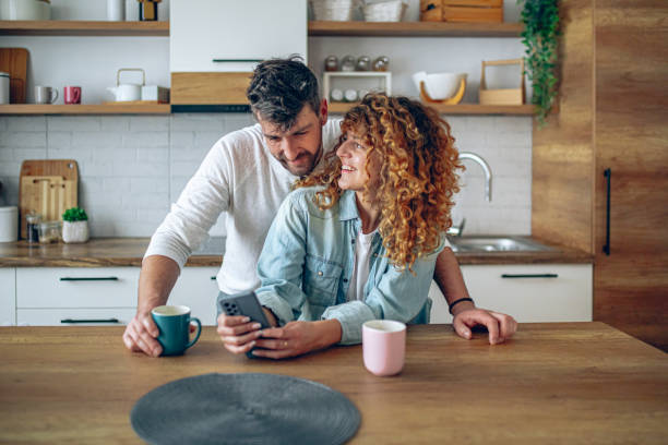 istock Romantic couple sharing a tender moment while having morning coffee in their contemporary kitchen 2192189747