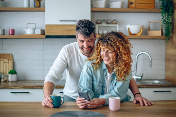 istock Romantic couple sharing a tender moment while having morning coffee in their contemporary kitchen 2192189772