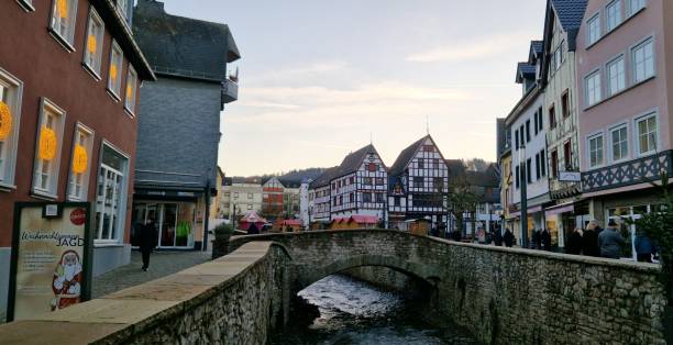 Stream, bridge and old timber frame houses inside the old walled town of Bad Muenstereifel, Germany, December 2024