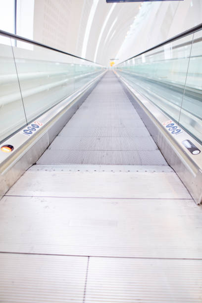 Moving walkway at a large airport.Vertical photo.
