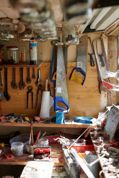 istock Organized workshop wall showcasing old tools and equipment for carpentry work. Great-grandfather's abandoned workshop. 2192194388