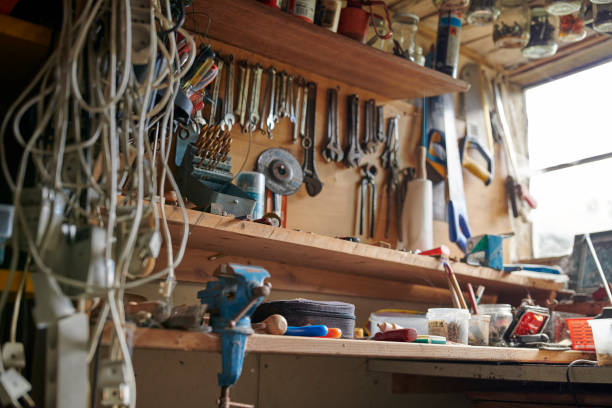 Workshop filled with tools and hardware, highlighting a workspace for dedicated repair and creativity. A mix of organized and lived-in charm, with emphasis on tools, metalwork, and utility.