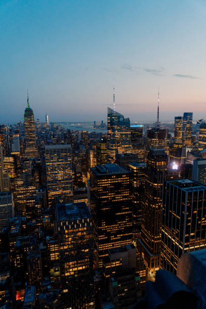 Experience the stunning skyline of NYC at dusk, showcasing iconic skyscrapers illuminated by vibrant city lights. Stunning and Breathtaking Sunset View Over the Iconic Manhattan Skyline