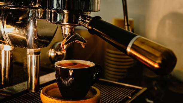 istock Espresso pouring from coffee machine at cafe,Brewing the espresso coffee from the machine 2192198677