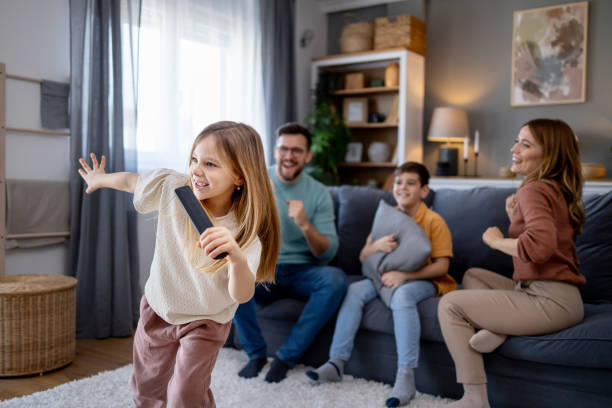 istock Child enthusiastically performs a dance for family 2192200220