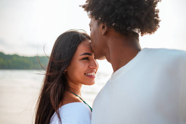 istock Intimate Beach Kiss Between Diverse Young Couple 2192200836