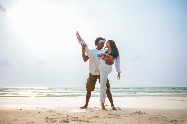 istock Joyful Beach Dance: Hispanic Woman and Black Man 2192200837