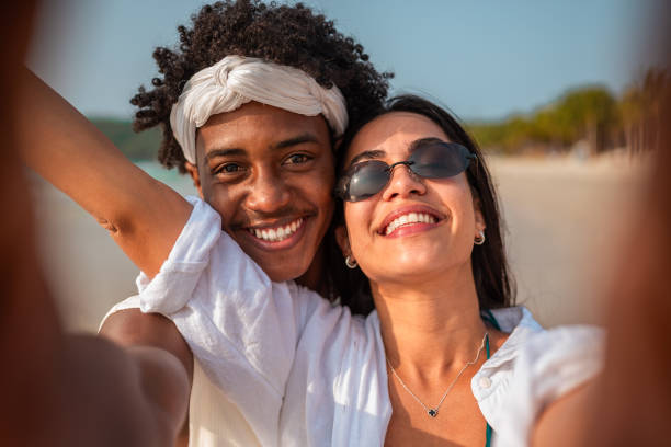 istock Joyful Diverse Couple Taking Selfie on Beach 2192200844