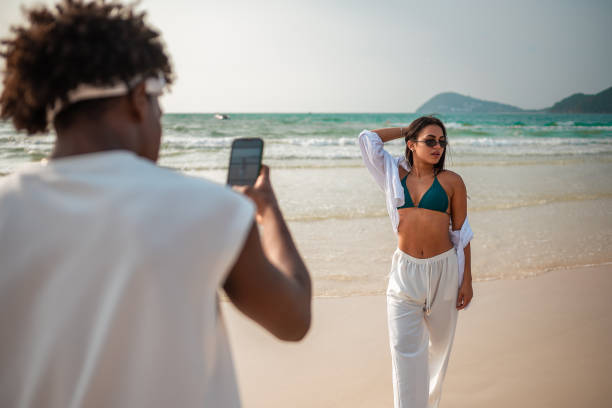 istock Young Couple's Beachside Photography Moment 2192200847