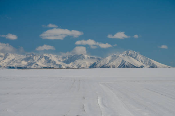 istock Snowfield and snow-covered mountains in early spring 2192204292