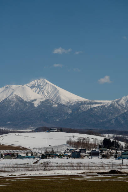 istock Farmland and snowy mountains in early spring 2192204315