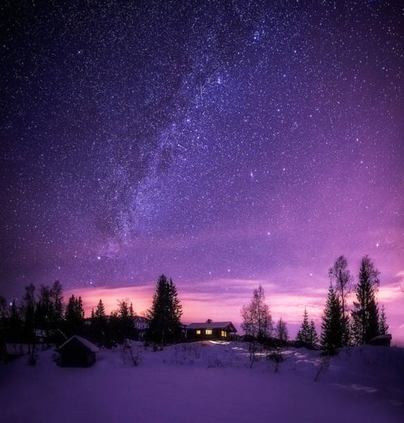 Mountain lodge beneath the night sky.