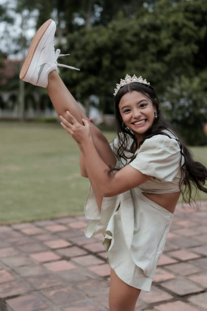 istock 15 years teenage girl smiling while performing dance stretch 2192207909