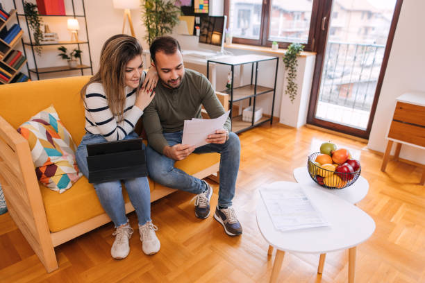 istock Happy couple paying their bills online at home. 2192207974