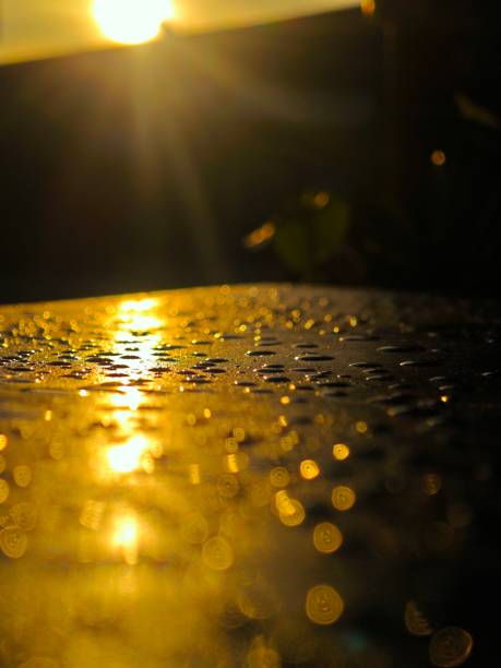 Raindrops on the surface of the table with a blurred background.