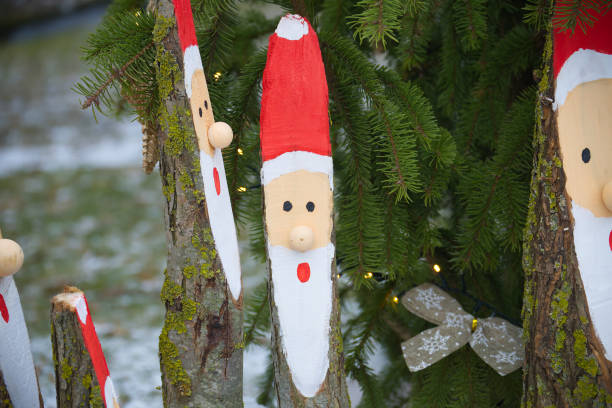 istock Handcrafted Wooden Santa Decorations Against Seasonal Pine Tree 2192212367