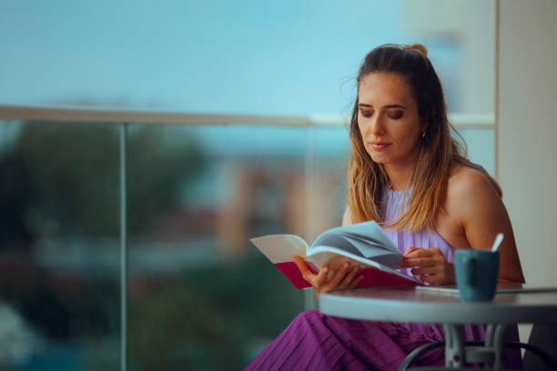 istock Woman Reading a Book in her Home Balcony Relaxing 2192212378