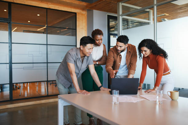istock Team Collaboration Around a Laptop in Bright Office 2192217029