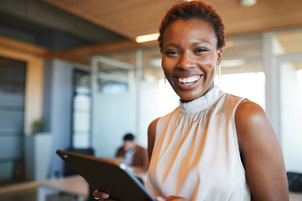 istock Confident Businesswoman Smiling with Tablet 2192217044
