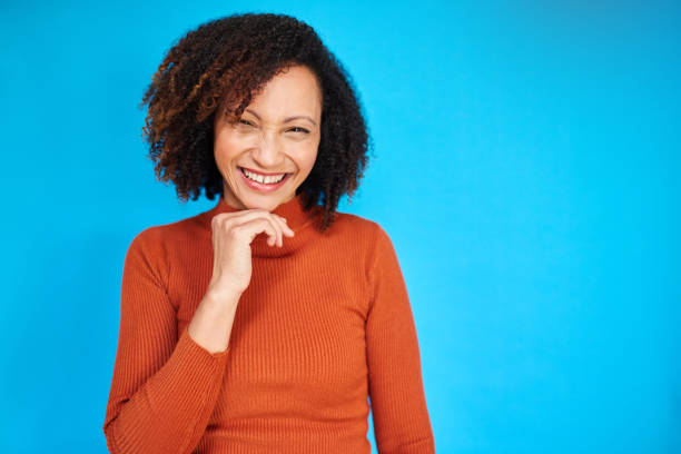 istock Joyful Woman Laughing Against Blue Backdrop 2192217377