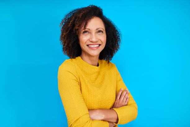 istock Confident Woman in Yellow on Blue 2192217406