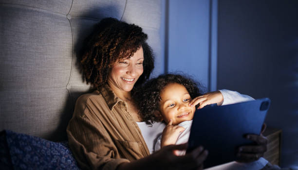 istock Bedtime Bonding: Mother and Child Sharing a Tablet 2192217471