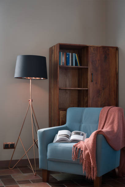 istock Comfortable Reading Area with Armchair, Lamp, and Bookcase 2192217915
