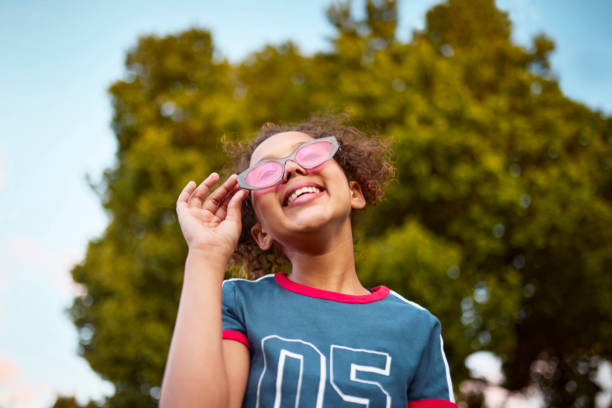 istock Joyful Girl with Pink Sunglasses Looking Up 2192218070