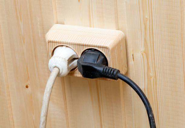 istock A wooden outlet box with two white plugs and a black plug 2192221574