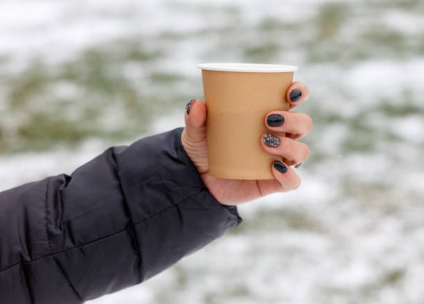 istock A person holding a cup with a black and white design 2192221637