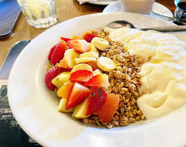 Chopped strawberries, bananas and apples combine with muesli and yogurt to make an enjoyable and healthy breakfast.