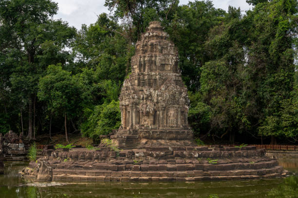 the temple is located in middle of the beautiful reservoir filled with lotus flowers