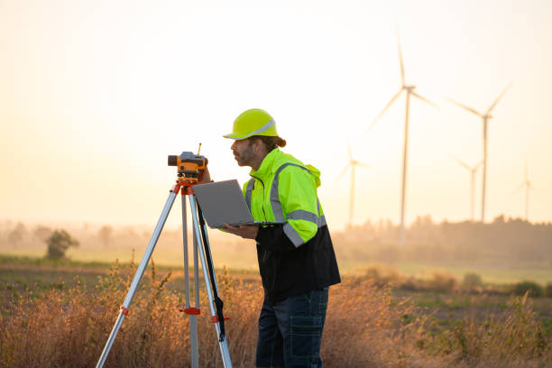 istock Engineer with laptop survey work in wind turbine farms rotation. 2192224540