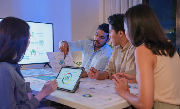 istock diversity team discussion about esg and eco friendly system planning in sustainable green office at night 2192224579
