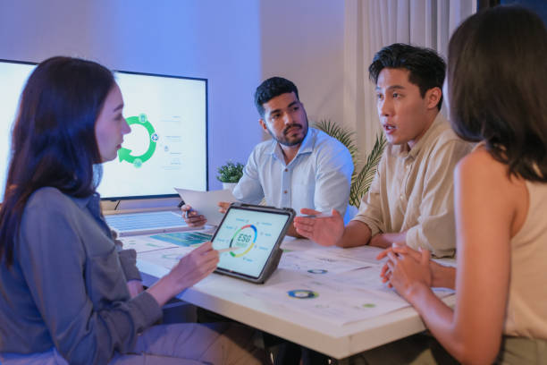 istock diversity team discussion about esg and eco friendly system planning in sustainable green office at night 2192224596
