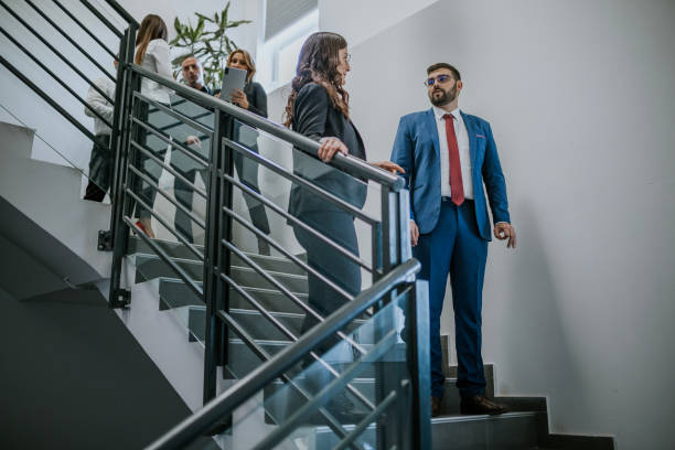 istock Team discussing business matters on a modern office staircase 2192225174