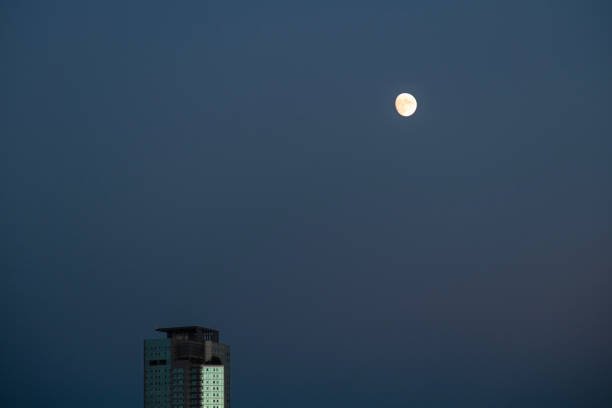 istock moon and skyscraper in the night 2192226248