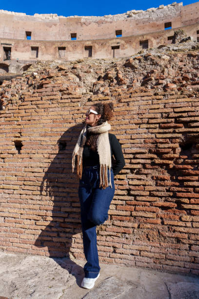 istock Mature traveler walking through ancient Roman ruins, exploring historical architecture under bright sunlight in iconic Italian landscape 2192228054