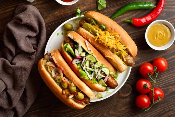 istock Hot dogs with different toppings on wooden background 2192228644