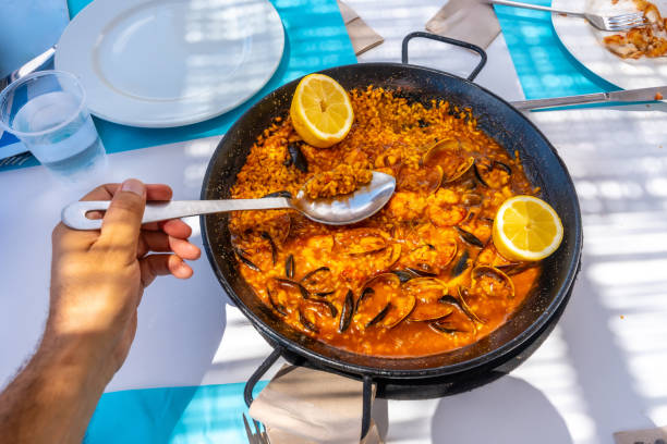istock Customer enjoying seafood paella outdoors in summer restaurant 2192228777