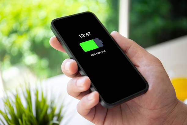 istock man hand holding phone with charged battery on the screen 2192229001