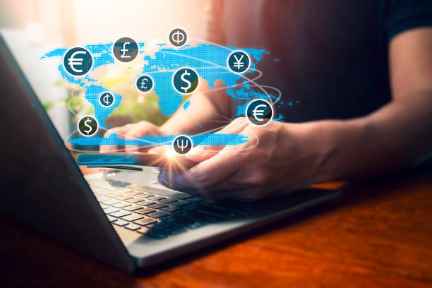 istock Man using smartphone and laptop with virtual screen international currencies. Currency exchange, money transfer, Global business, online banking, interbank payment concept. 2192229080