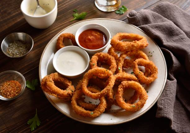 Fried breaded onion rings served with sauce