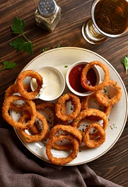 istock Fried breaded onion rings served with dipping sauce 2192229353
