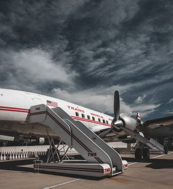 New York, United States – August 05, 2022: A vintage airplane on display at the TWA Hotel in New York, showcasing classic aviation design under a partly cloudy sky.