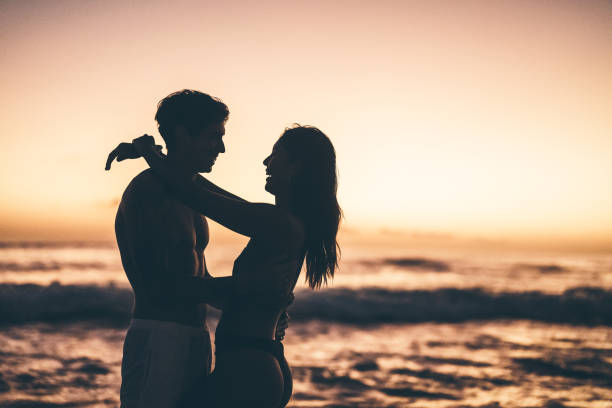istock Romantic couple embracing on a beach during a picturesque sunset moment 2192230320