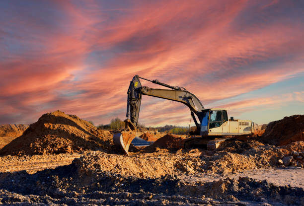 istock Excavator on earthworks at construction site. Backhoe on earthmoving and foundation work. Heavy machinery and equipment. 2192231198